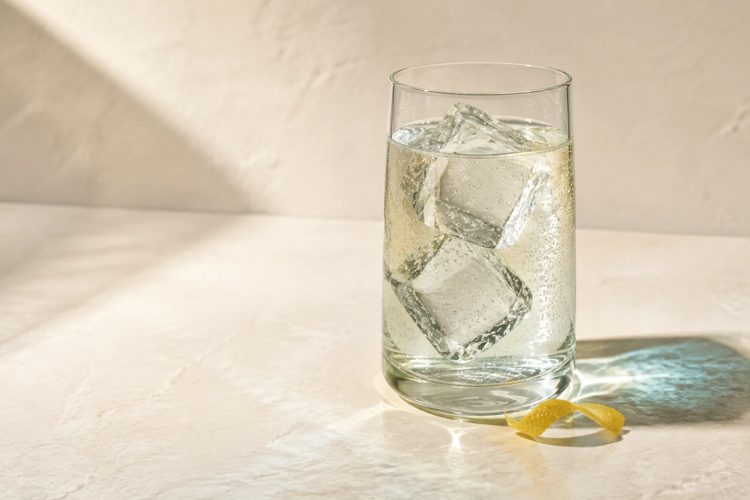 Illustrative sparkling clear beverage with ice and delicate bubbles